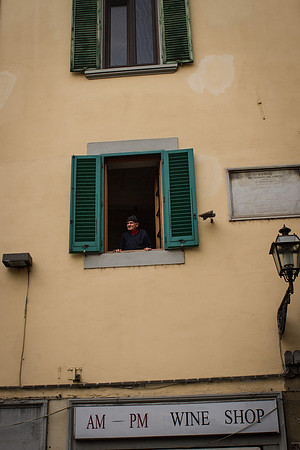 Man looking out window